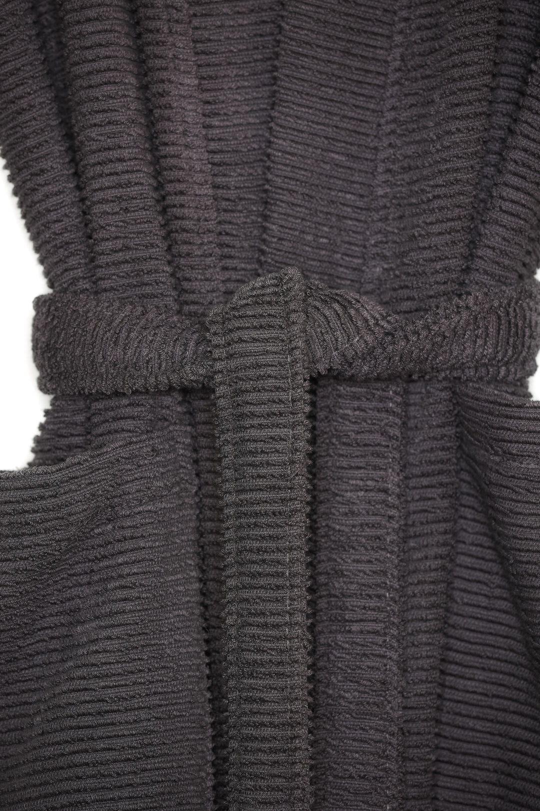 close up of dark grey cotton terry spa robe on a hanger against a white background #colour_charcoal