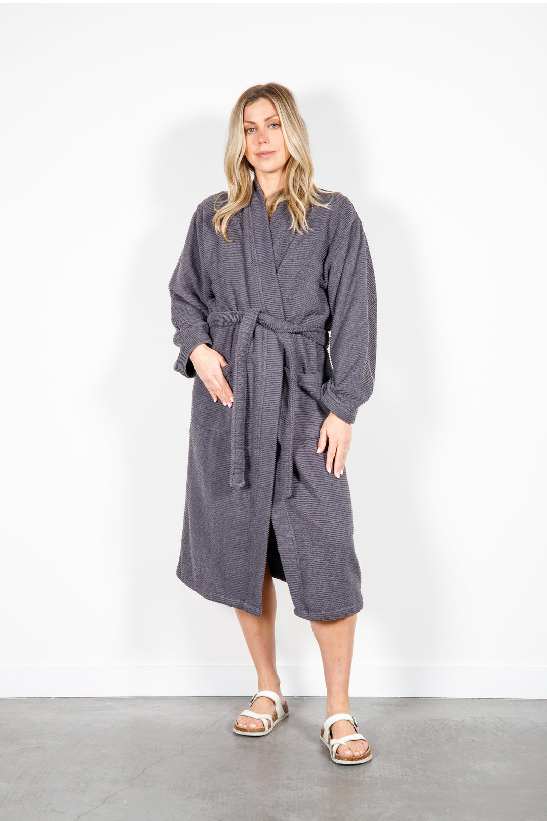 woman wearing mid length dark grey cotton terry relaxed fit spa robe #colour_charcoal