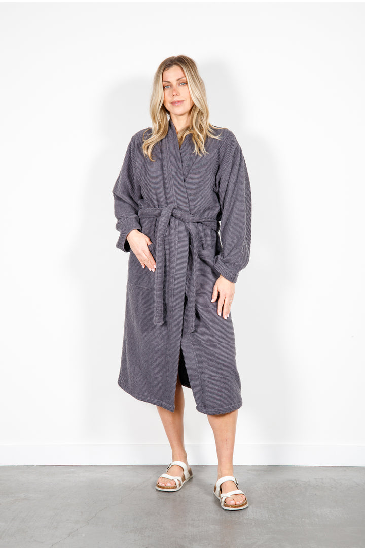 woman wearing mid length dark grey cotton terry relaxed fit spa robe #colour_charcoal