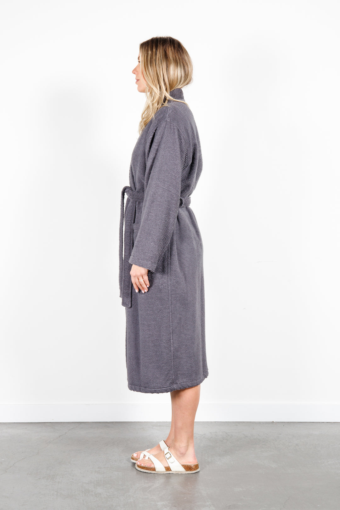 woman wearing mid length dark grey cotton terry relaxed fit spa robe #colour_charcoal