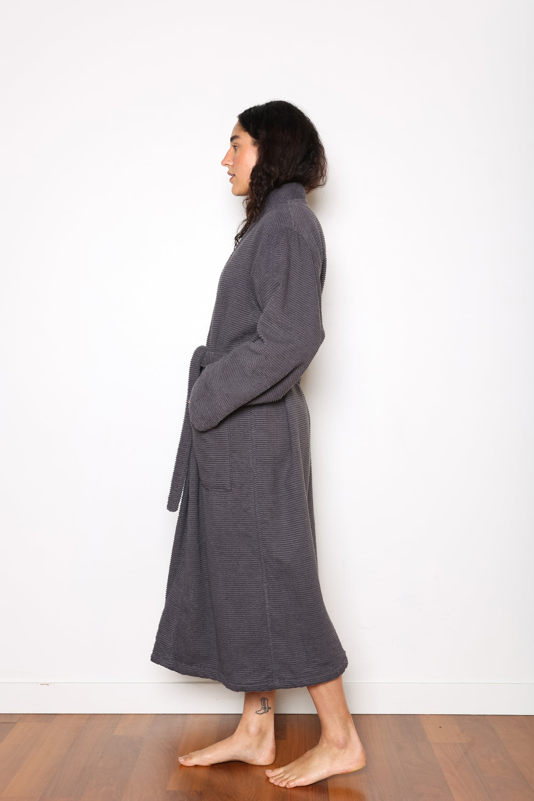 woman wearing mid length dark grey cotton terry relaxed fit spa robe #colour_charcoal