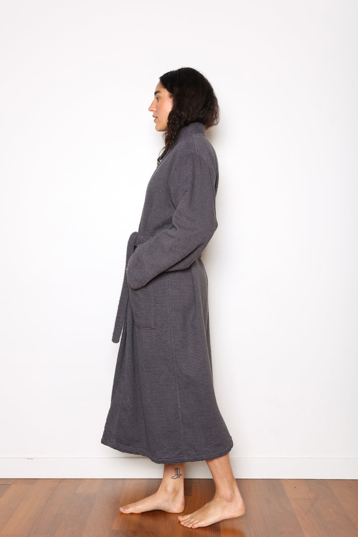 woman wearing mid length dark grey cotton terry relaxed fit spa robe #colour_charcoal