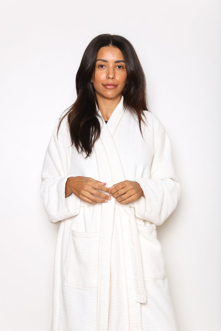 woman wearing mid length white cotton terry relaxed fit spa robe #colour_off-white