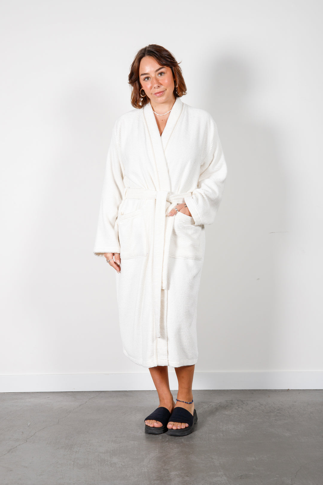 woman wearing mid length white cotton terry relaxed fit spa robe #colour_off-white