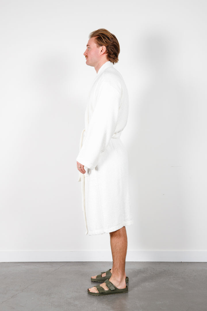 man wearing mid length white cotton terry relaxed fit spa robe #colour_off-white