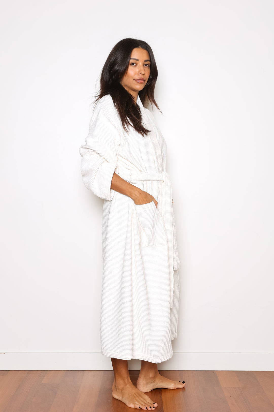 woman wearing mid length white cotton terry relaxed fit spa robe #colour_off-white