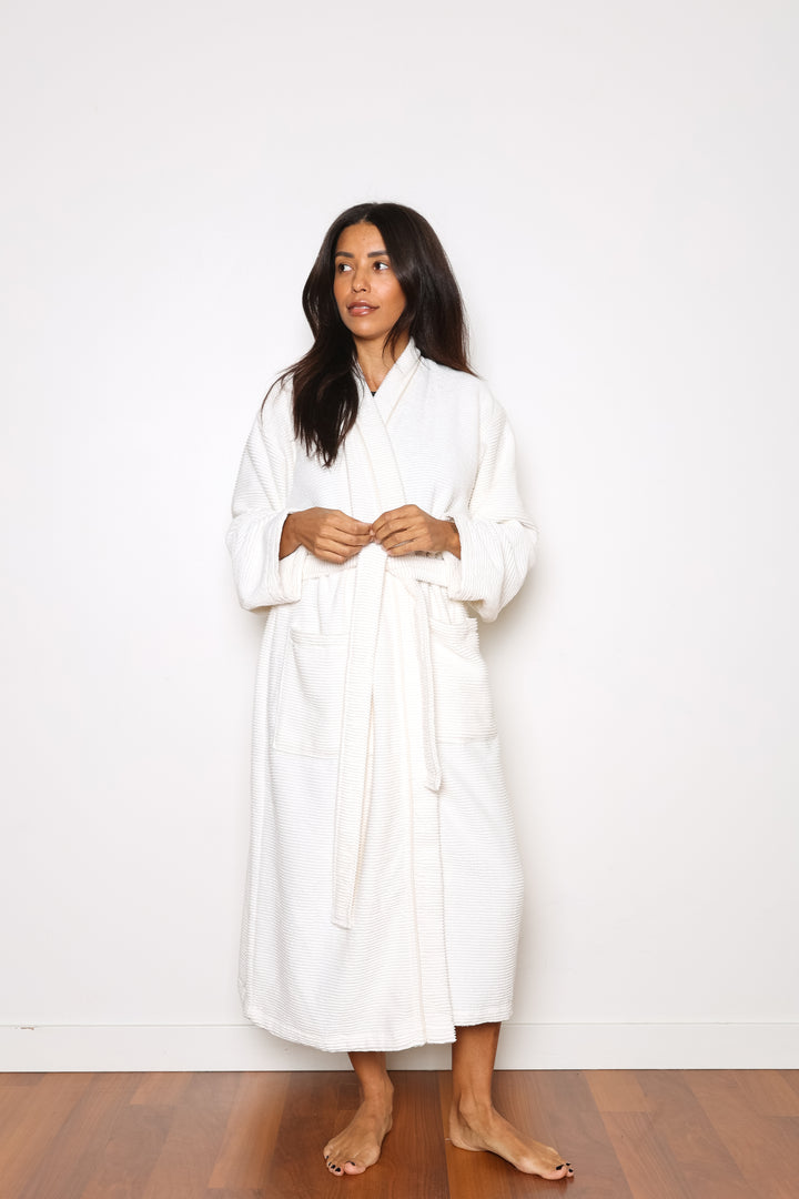 woman wearing mid length white cotton terry relaxed fit spa robe #colour_off-white