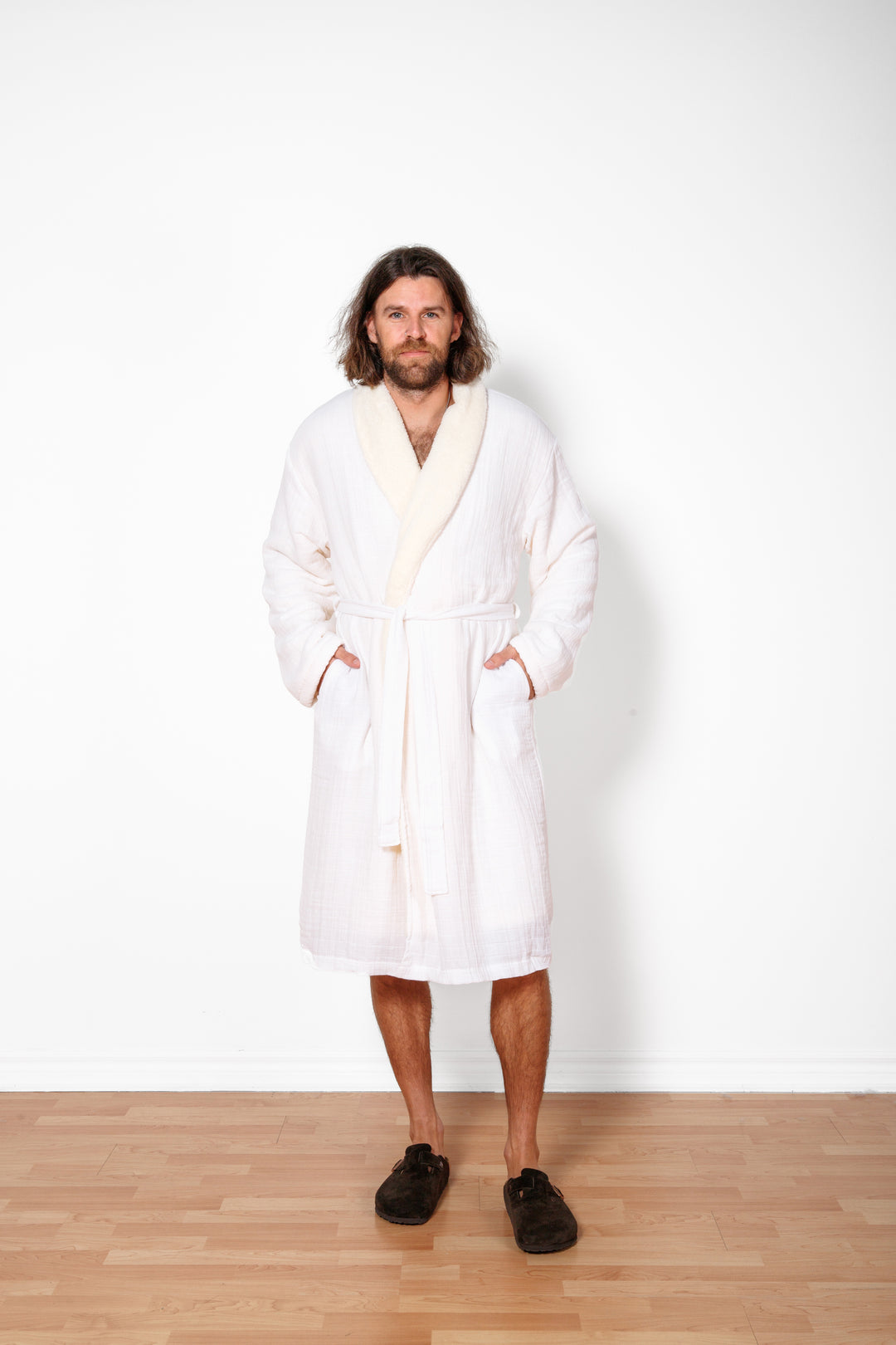 a man wearing long white belted fleece lined muslin robe with pockets. #colour_white