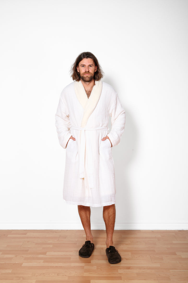 a man wearing long white belted fleece lined muslin robe with pockets. #colour_white