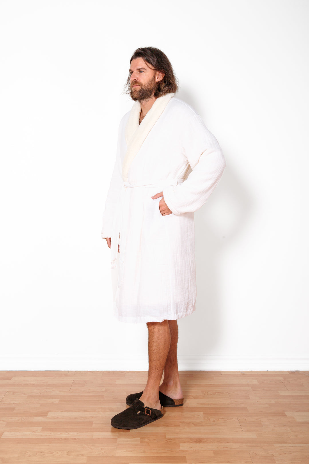 a man wearing long white belted fleece lined muslin robe with pockets. #colour_white