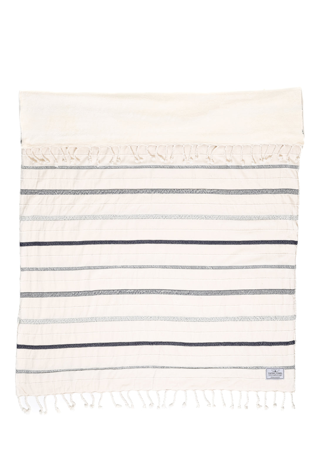 A fleece throw blanket with a striped pattern in navy and white, featuring rope-like stitch detailing and tassels at the edges.