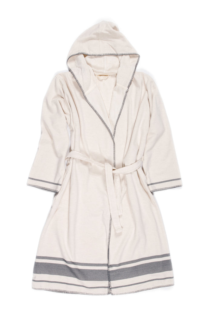 A medium length beige hooded belted terry robe with gray stripes, and pockets. Laying flat on a white background