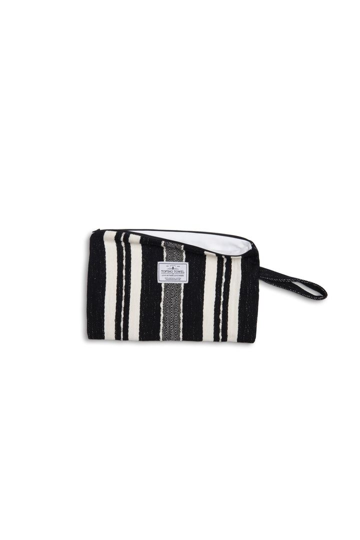 Black zip up pouch with white stripes and a wrist handle  on a white background