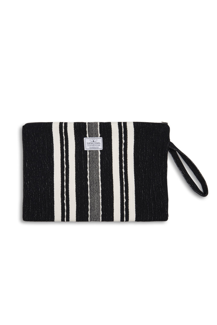 Large black zip up pouch with white stripes and a wrist handle on a white background