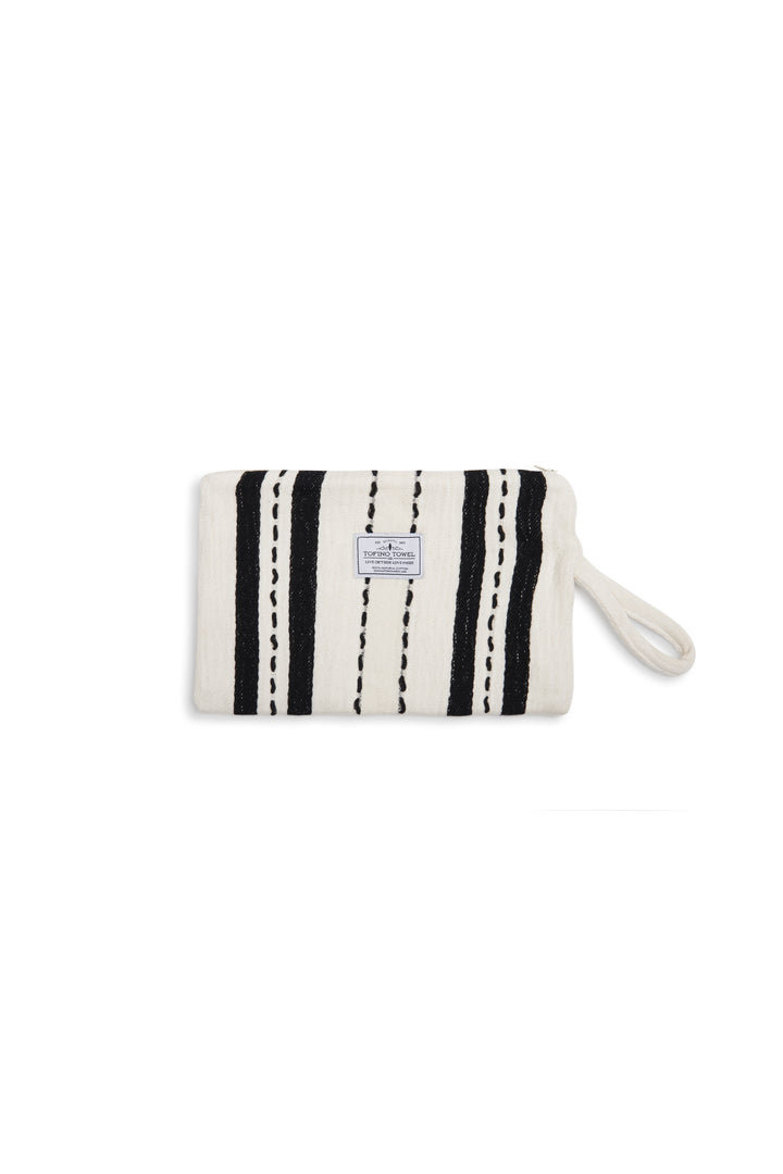 White zip up pouch with black stripes and a wrist handle  on a white background