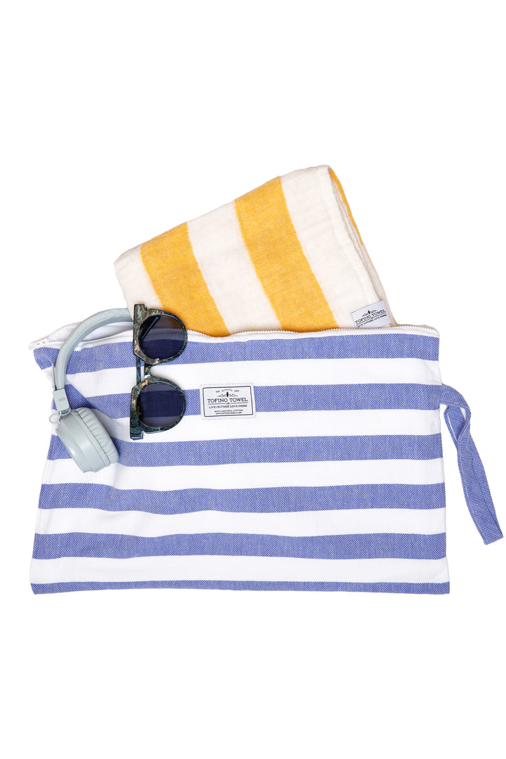 large white and blue striped zip up pouch with wrist handle containing accessories on a white background #colour_blue-stripes