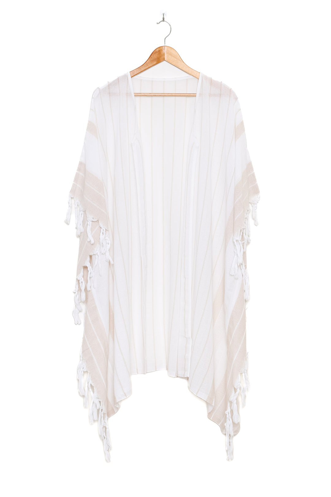 A white open cover-up with subtle stripes and tassels, on a hanger against a white background
