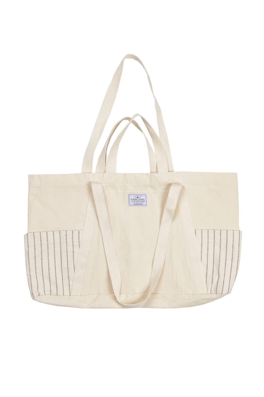 Large off white Turkish cotton canvas tote bag with exterior pockets, handles laid flat on a white background