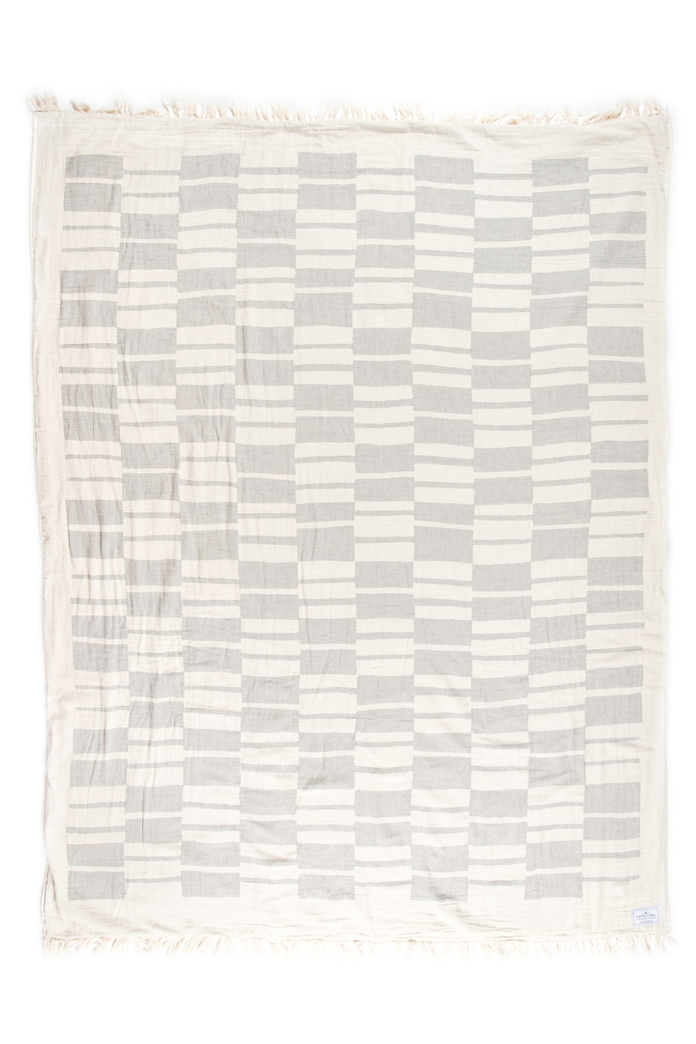 off white and light grey fleece lined throw with modern checker board pattern and eyelash fringe laid flat on a white background #colour_pewter