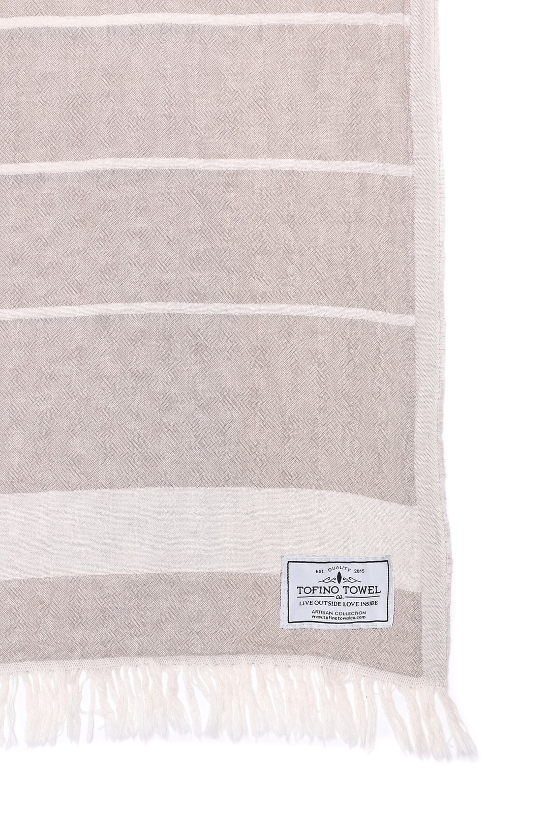 close up of beige and off white fleece lined throw with eyelash fringe on a white background #colour_beige