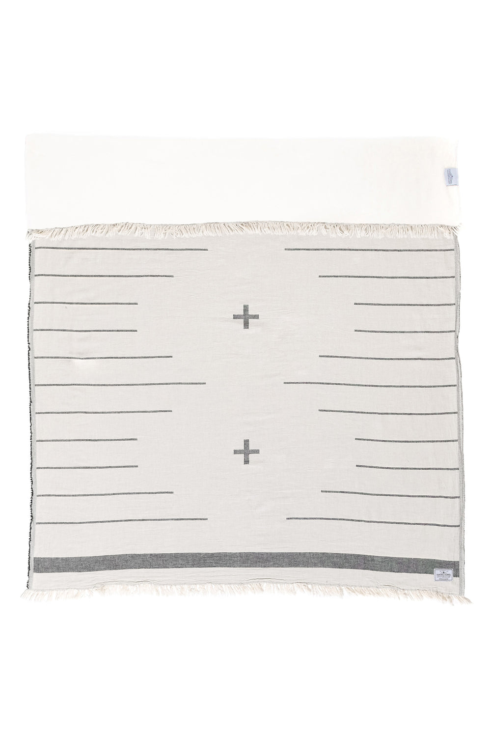 off white  fleece lined throw with a minimal modern design in dark grey and eyelash fringe laid flat with one side folded down on a white background #colour_whitecap