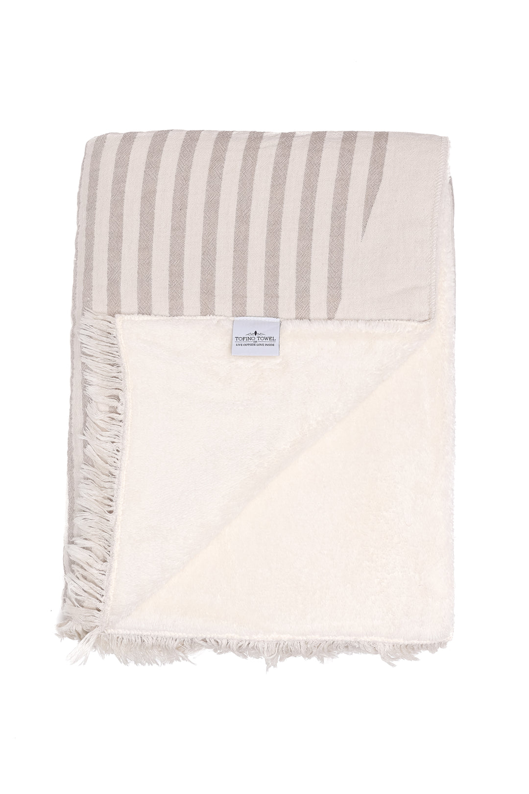 off white and baige fleece lined throw with eyelash fringe folded with one corner turned back on a white background #colour_beige