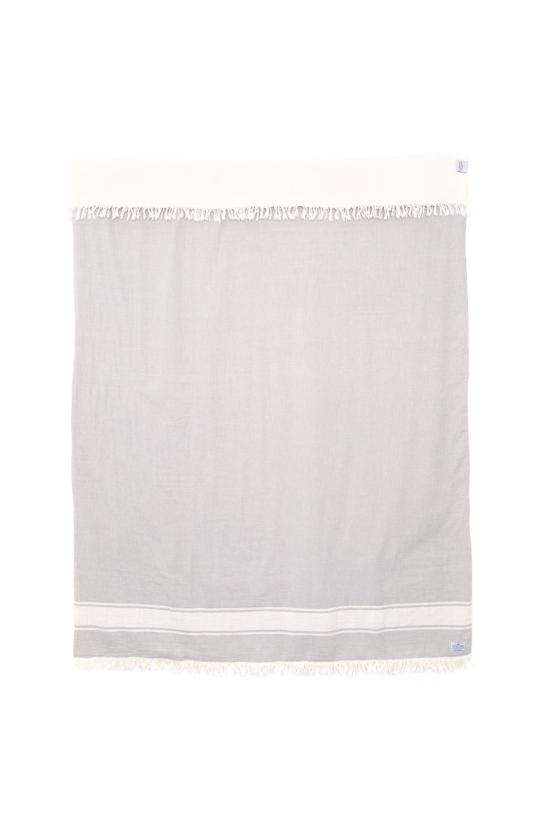 A light-gray fleece-lined throw with eyelash fringe, and simple, stylized white stripe displayed on a white background. #colour_pewter