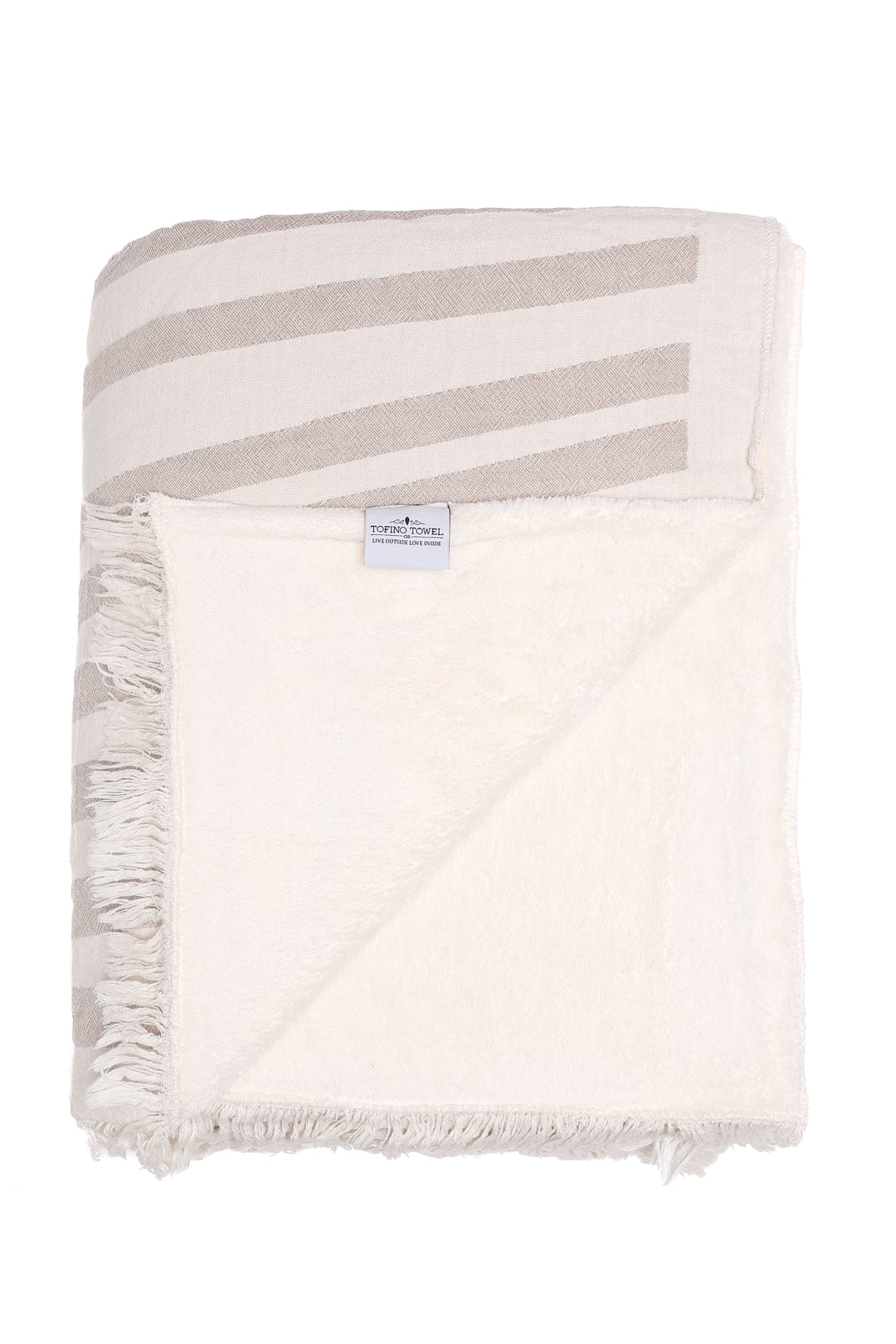off white and beige fleece lined throw with modern ripple effect stripe design with eyelash fringe folded with one corner turned backon a white background#colour_beige