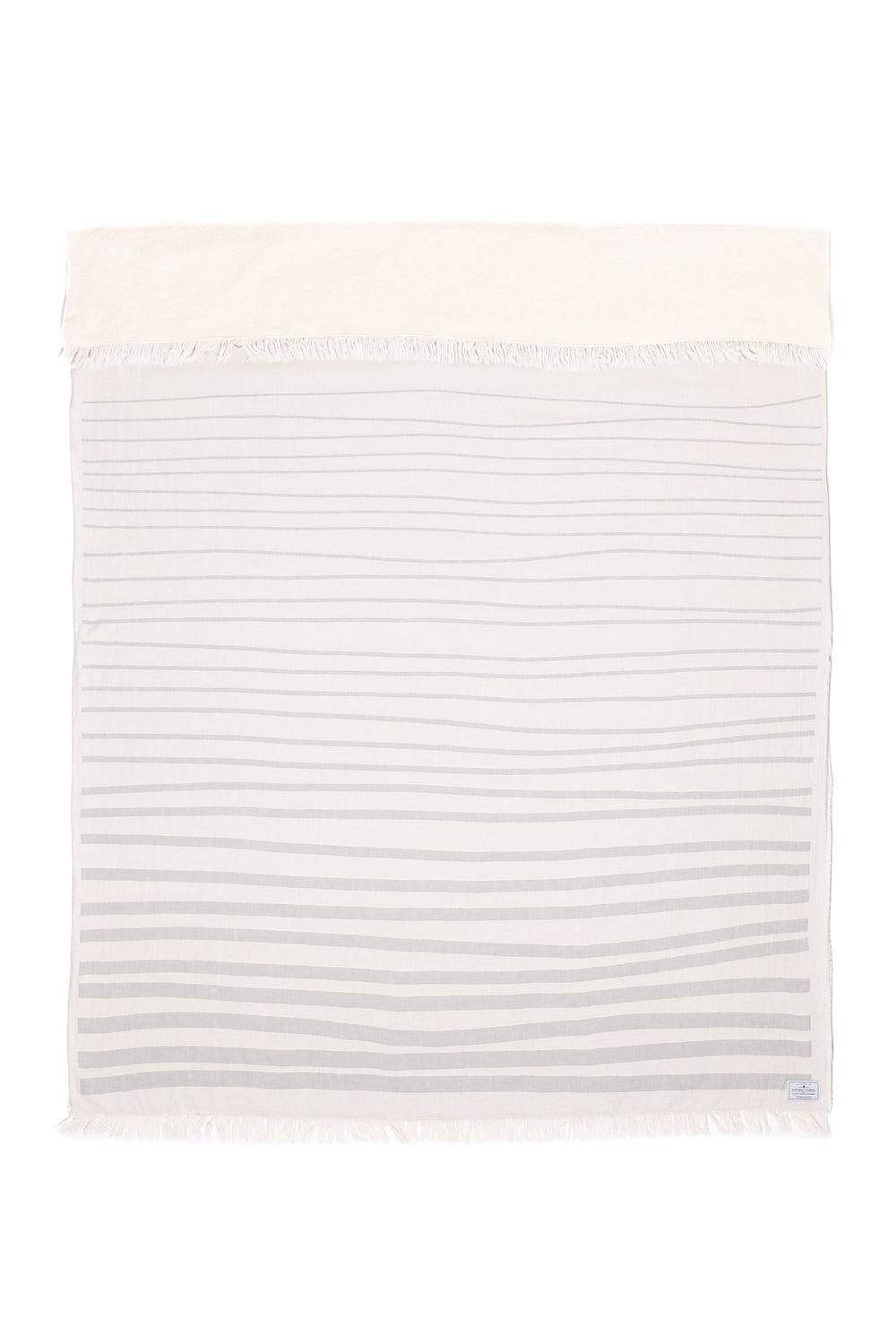 off white and light grey fleece lined throw with modern ripple effect stripe design with eyelash fringe laid flat with one side folded down on a white background #colour_pewter