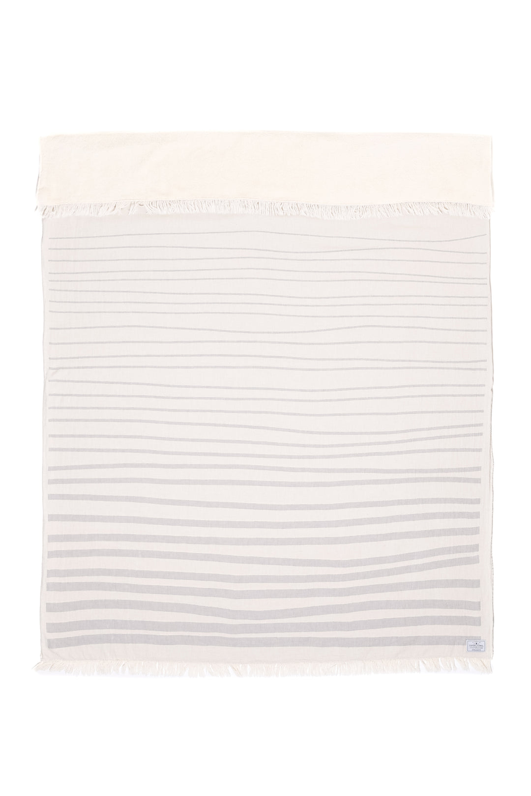 off white and light grey fleece lined throw with modern ripple effect stripe design with eyelash fringe laid flat with one side folded down on a white background #colour_pewter